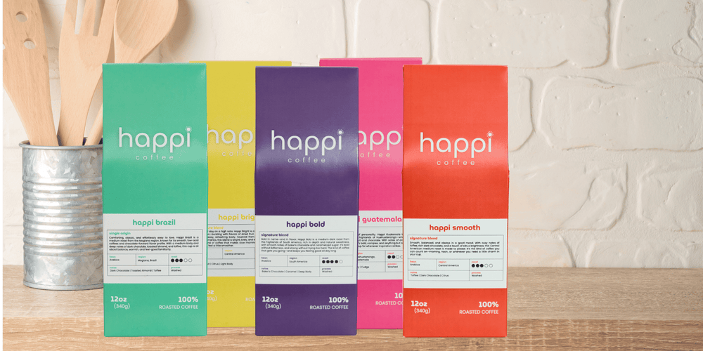 Happi Coffee’s best-selling coffee bags displayed on a kitchen counter—featuring Brazil, Bright, Bold, Guatemala, and Smooth blends in vibrant packaging.