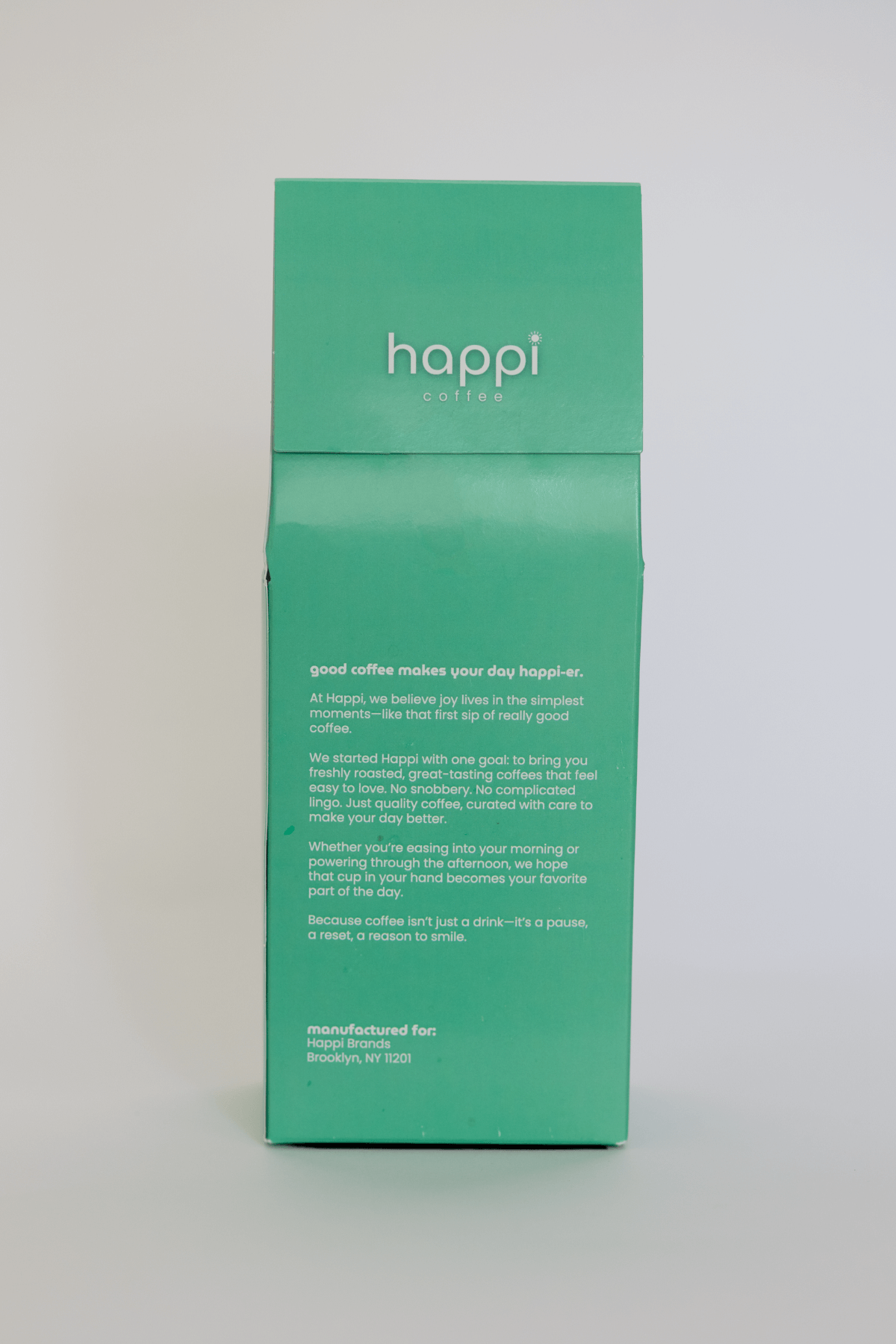Back view of 12 oz bag of happi brazil dark roast coffee – available in whole bean or ground