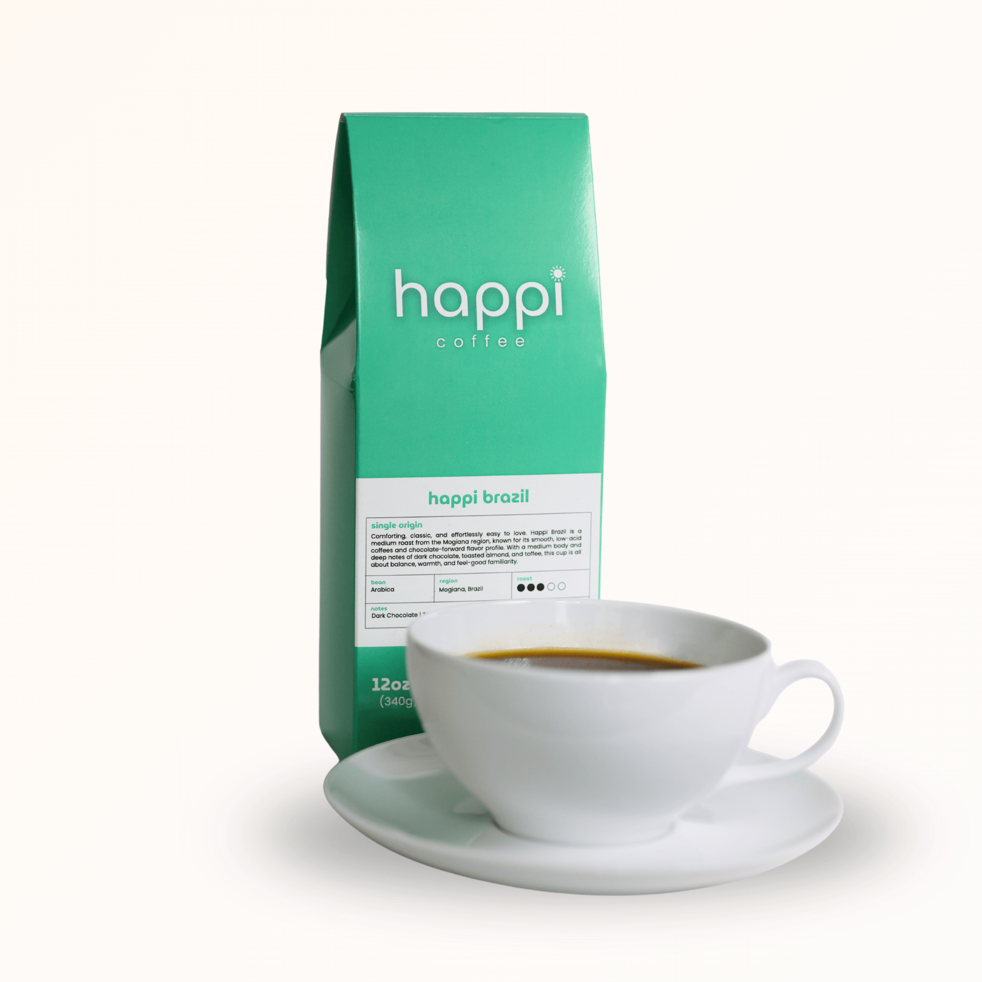 Side view of 12 oz bag of Happi Brazil with cup of coffee. Best Medium Roast Coffee Beans with Chocolate, Almond & Toffee Notes, Available Ground or Whole Bean