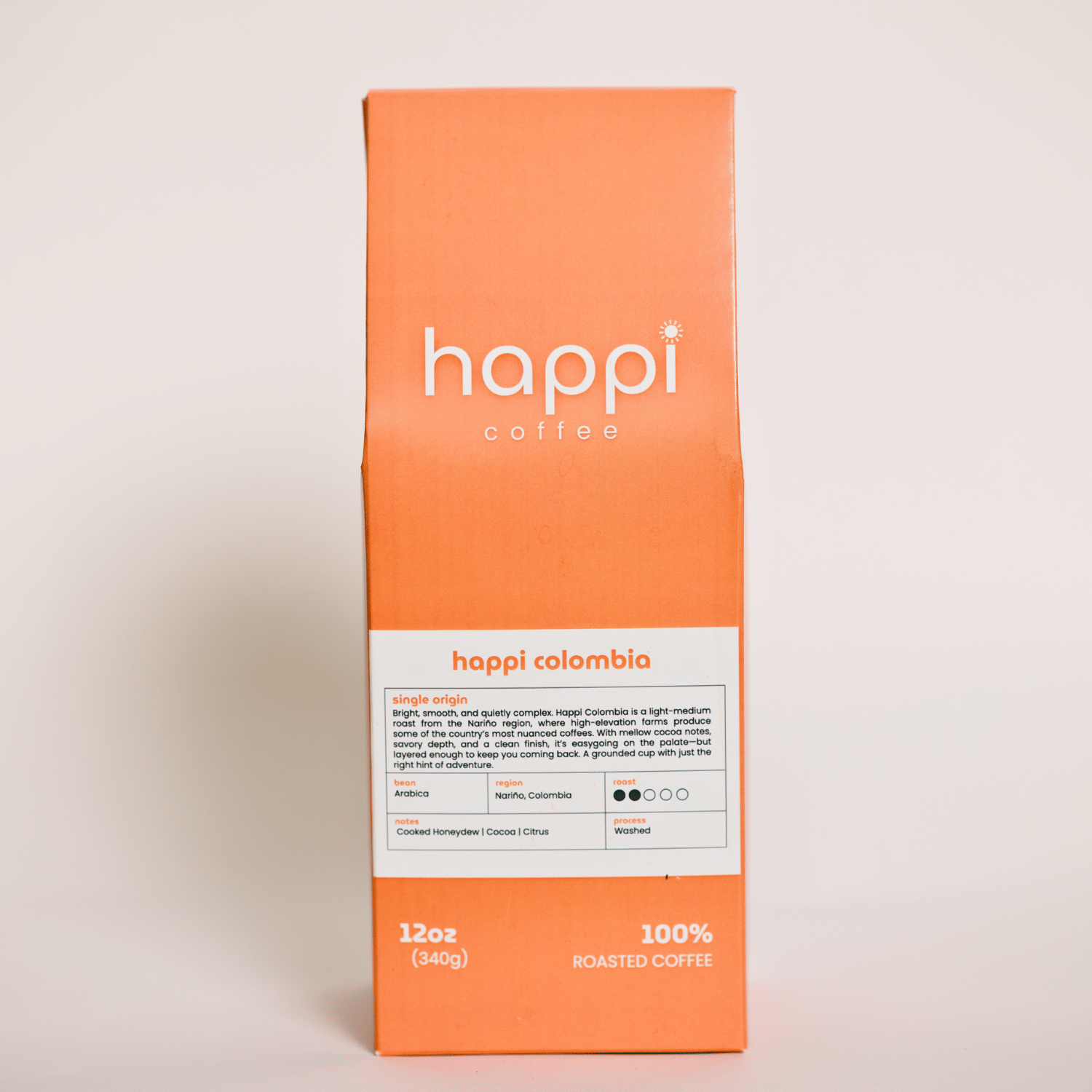 Front view of 12 oz bag of happi colombia light roast coffee – available in whole bean or ground