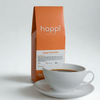 View of 12 oz bag of happi colombia light roast coffee next to a cup of coffee – available in whole bean or ground