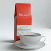 View of 12 oz bag of Happi Smooth next to a cup of coffee. Best Medium Roast Coffee Beans with Cozy Sweetness & Balanced Flavor, Available Ground or Whole Bean