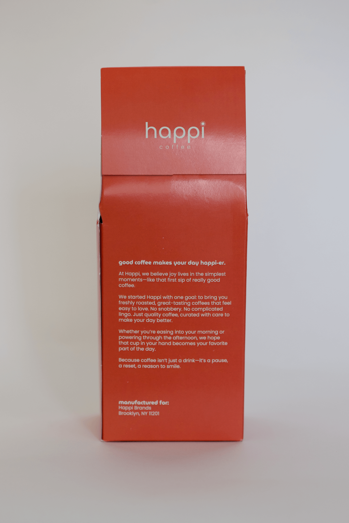 Back view of 12 oz bag of happi smooth medium roast coffee – available in whole bean or ground